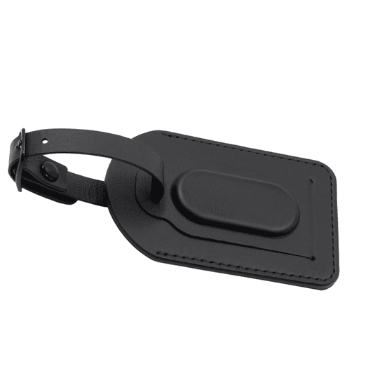 A black luggage tag with a textured surface and a sturdy attachment strap. It features a smooth, raised centre.