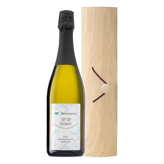 A drink bottle of sparkling wine in a birch cylinder, featuring a natural wood finish and a dark cap.