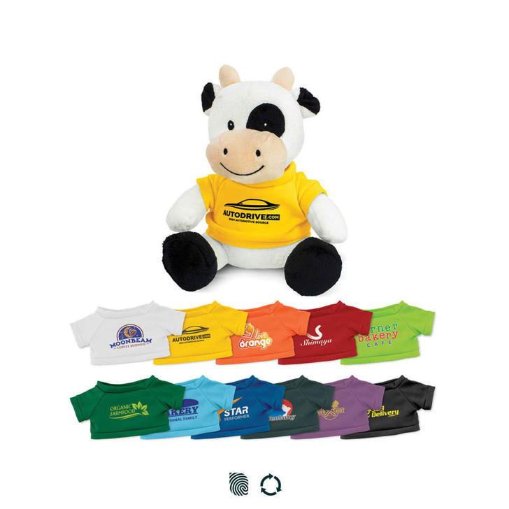 A plush toy cow in a yellow shirt, seated with various colourful shirts displayed below it. The toy features a logo.