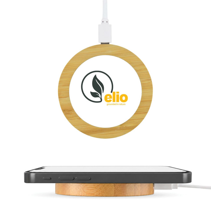 A round bamboo wireless charger in natural tones with a connected cable and a logo on the surface.