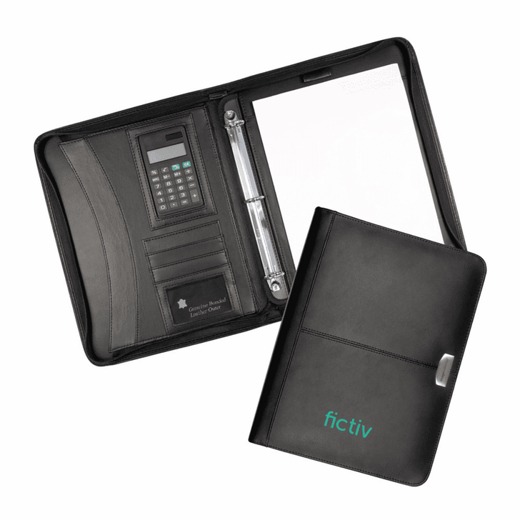 A black leather zippered compendium features a calculator, card slots, and a notepad holder. It has a branding logo.