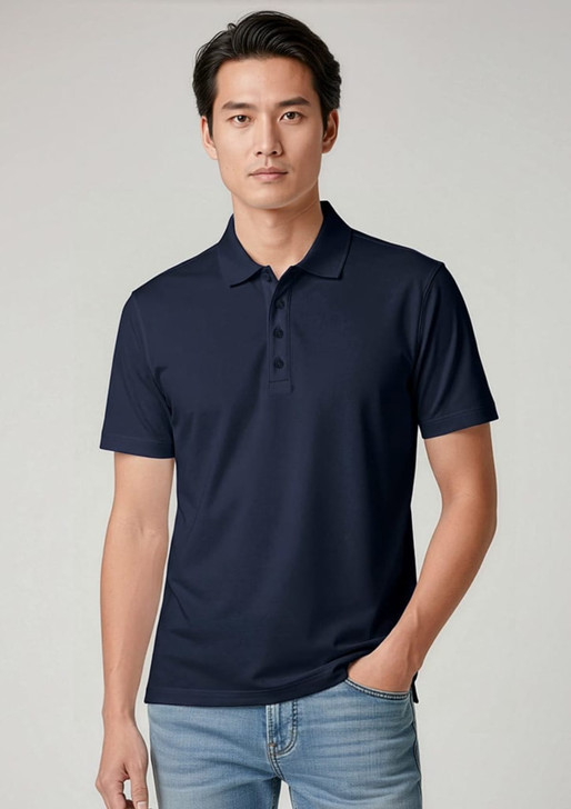 A navy short sleeve polo shirt featuring a collar and a branded logo. Model wears it with light blue jeans.