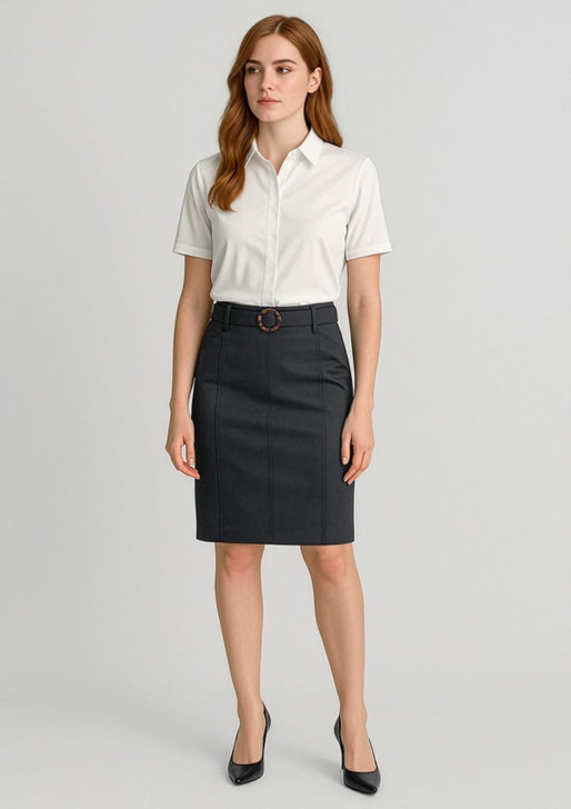 A woman stands in a fitted dark grey mid-waist chino skirt with a belt, paired with a white short-sleeve shirt.