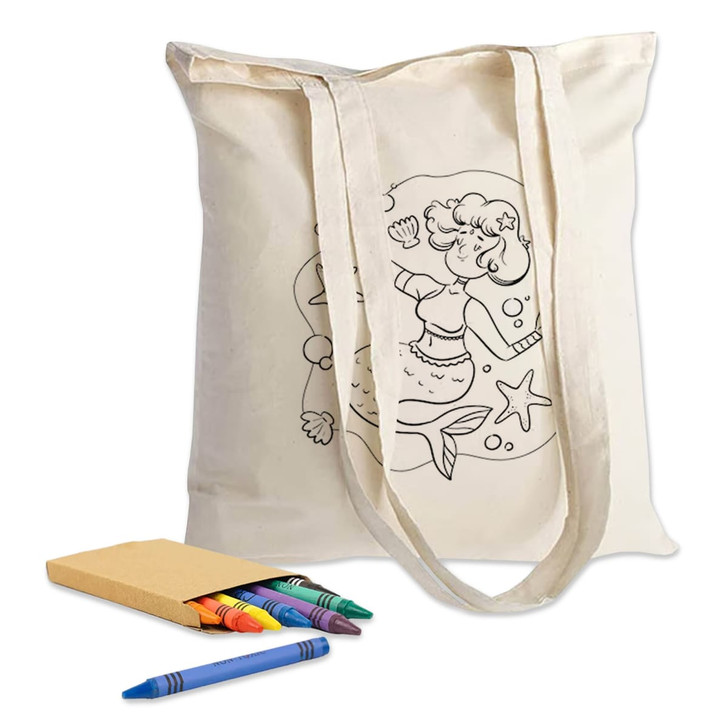 A cream calico tote bag with colouring design, accompanied by crayons and a notebook.