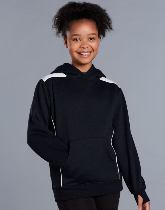 A young girl wearing a navy blue hoodie with white contrast detailing and a kangaroo pocket.