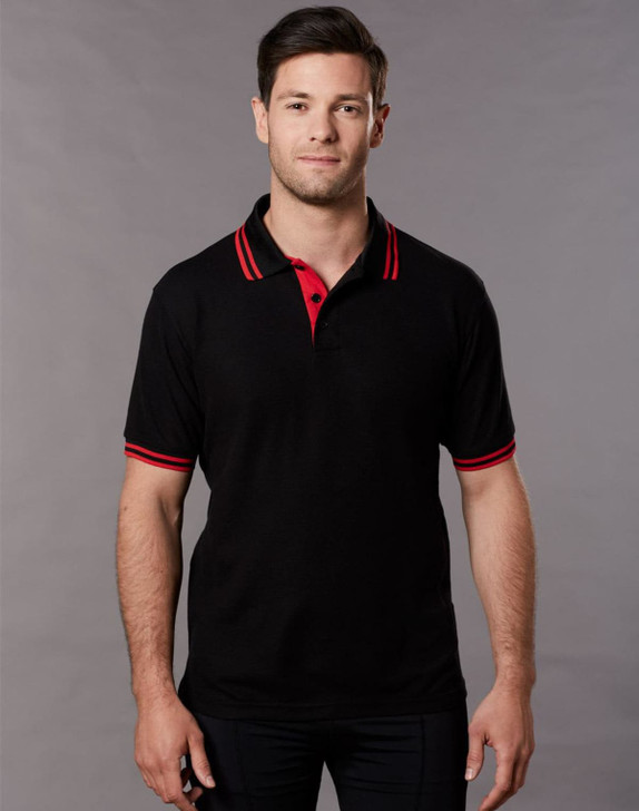 A black polo shirt with red collar and sleeve stripes, featuring a logo on the chest.