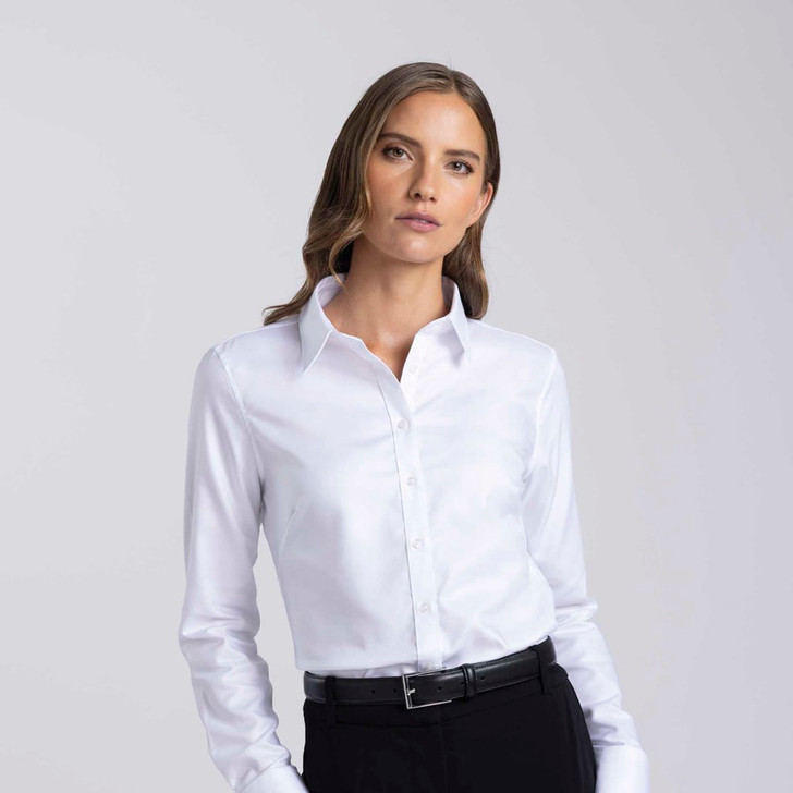 A women's button-up shirt in white with a collar and long sleeves. It features a sleek design and has a logo.