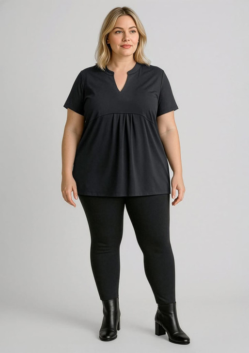 A model wears black high-rise pull-on corporate leggings paired with a black top and ankle boots. The image features a logo.