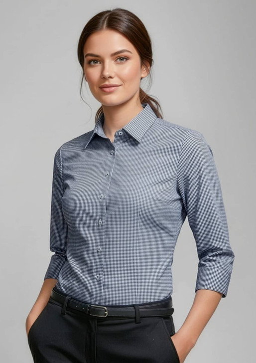A women's blue and white checkered 3/4 sleeve button-up shirt with a collar, featuring a logo on the front.