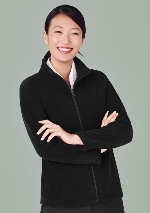 A black women's plain micro fleece jacket with a zipped front, featuring a logo, worn by a smiling woman.