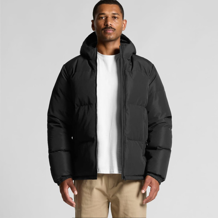 A black hooded puffer jacket featuring a front zipper and a logo, worn by a model against a neutral background.