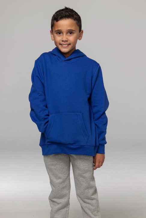 A child in a blue hoodie with a front pocket, wearing grey pants, posing against a neutral background.