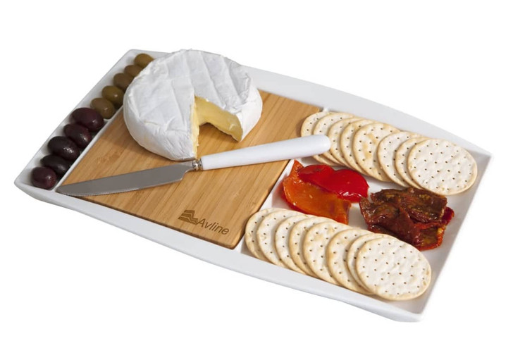 A white Jumbo Party Plate featuring a round cheese, crackers, olives, sundried tomatoes, and a knife on a wooden cutting board.