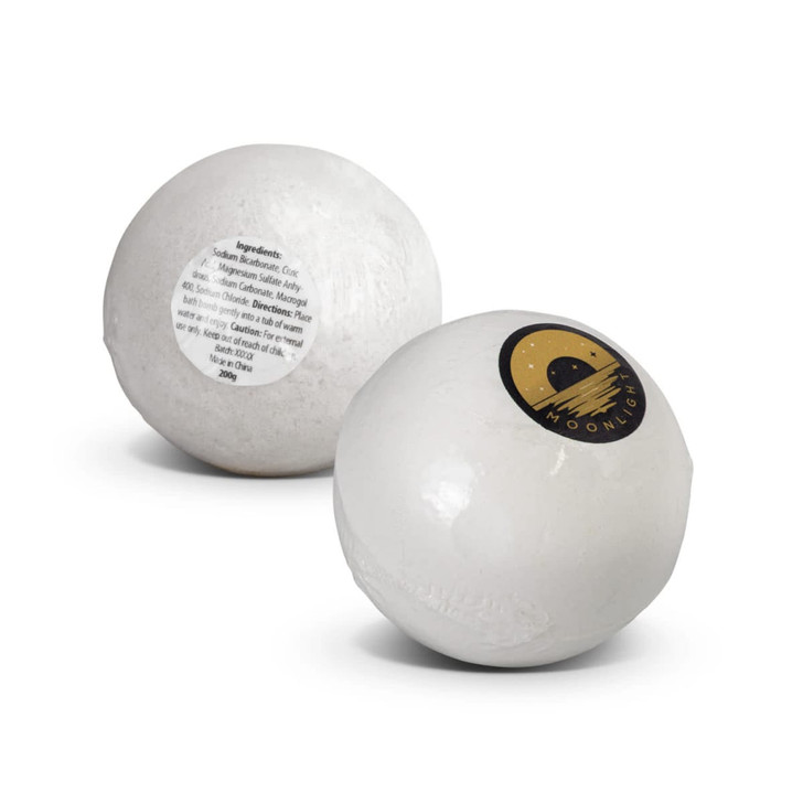A white bath bomb with a logo featuring a crescent moon, displaying a label with ingredients.