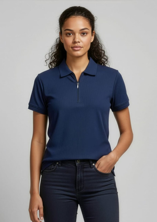 A navy women's micro waffle short sleeve polo with a zip collar and a logo. The model is wearing it with dark jeans.