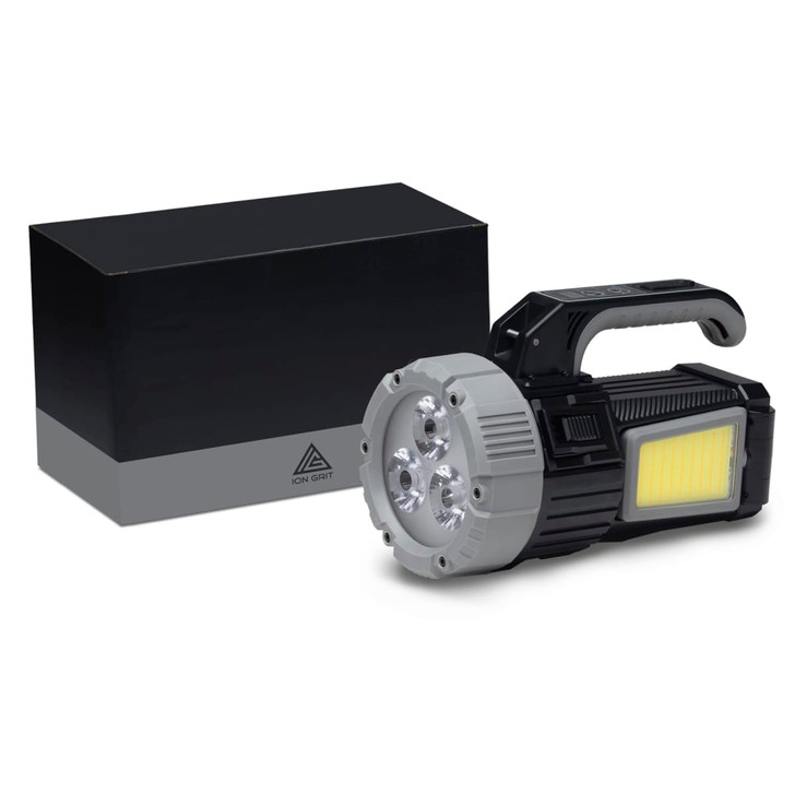 A black and silver OptiBeam Torch positioned next to a black box, featuring a handle and multiple light sources.