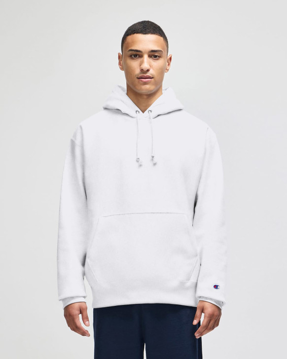 A grey hooded sweatshirt with a front pocket, featuring a logo on the sleeve, worn by a model.