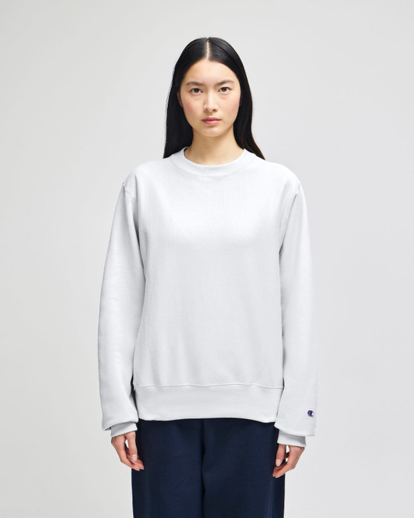 A grey Champion Reverse Weave® adult crew sweatshirt worn by a model, featuring a branding logo.