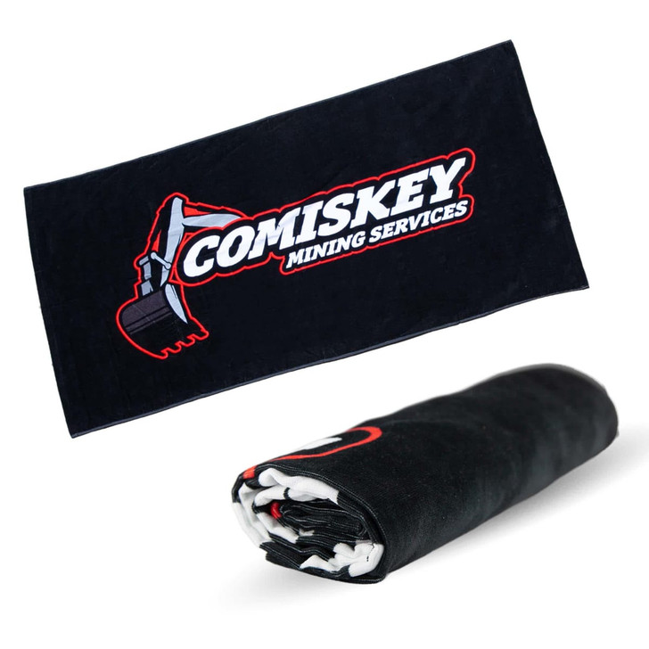 A black beach towel featuring a logo, measuring 75cm x 150cm, prominently displayed when rolled out.