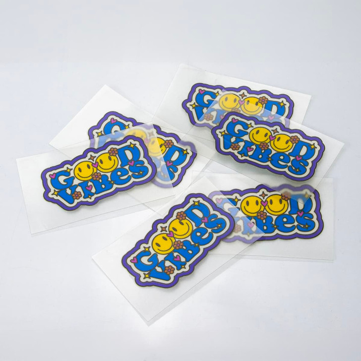 A collection of colourful stickers featuring playful designs and a logo on a white background.