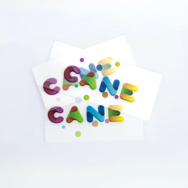 Colourful, playful sticker letters in varying shades with polka dots on white backing paper.