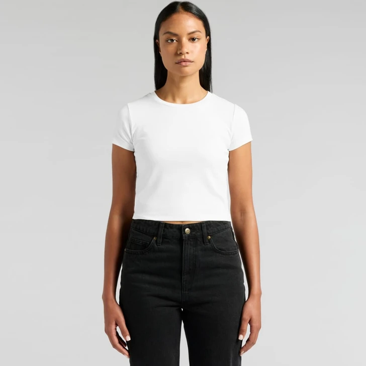 A white crop t-shirt displayed on a model wearing black jeans. The shirt features a simple design and has a logo.