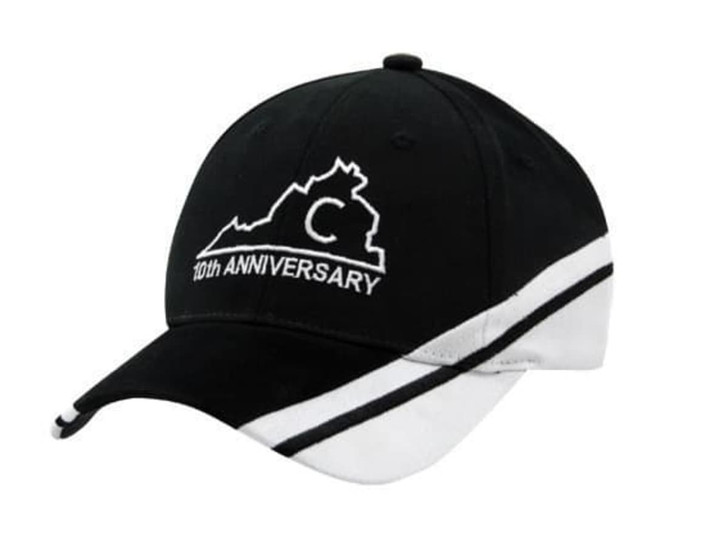 A black and white cap with a logo and text indicating a 10th anniversary.
