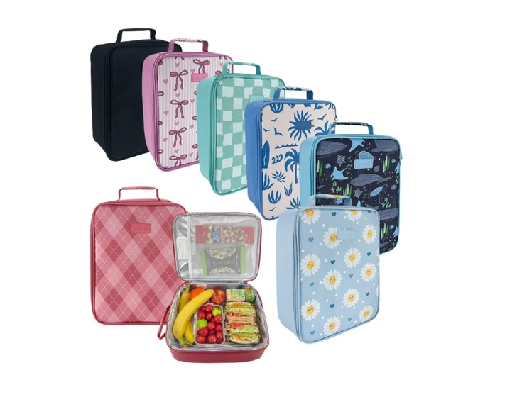 A selection of Sachi Insulated Junior XL Lunch Bags in various colours and patterns, including floral and checkered designs.