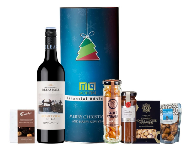 A bottle of Shiraz wine, caramel treats, popcorn, chocolate, and assorted snacks in a festive hamper.