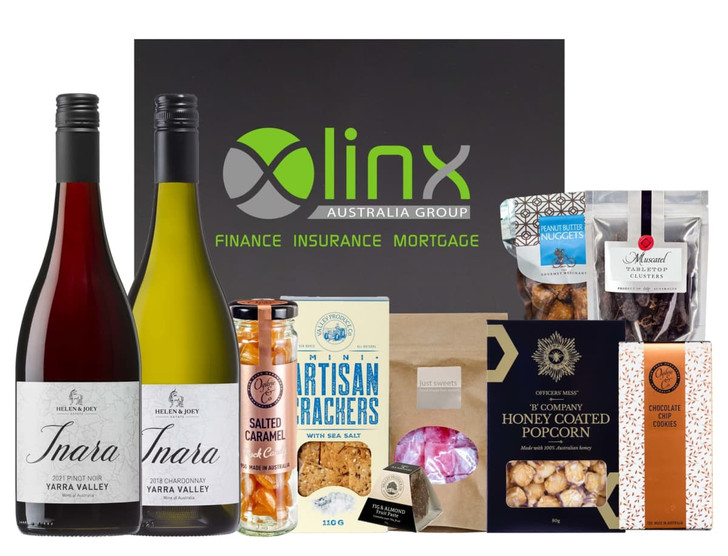 A wine hamper featuring two bottles of red wine, gourmet snacks, honey-coated popcorn, and a selection of confectionery.