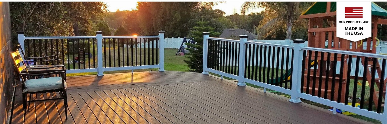 Sun setting over a beautiful deck with white balusters and black post caps.