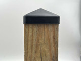 Side view of a 4x4 black steel post cap on a 3.5" wood post.