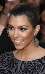 Kourtney Kardashian glows in bright red dress