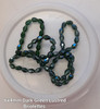 Strand of faceted drop glass beads (briolettes) - approx 6x4mm, Dark Green Lustered , approx 72 beads