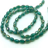 Strand of faceted rice glass beads - approx 6x4mm, Teal AB, approx 72 beads