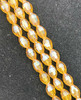 Strand of faceted rice glass beads - approx 6x4mm, Amber AB , approx 72 beads