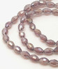 Strand of faceted rice glass beads - approx 6x4mm, Light Plum AB, approx 72 beads