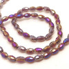 Strand of faceted rice glass beads - approx 6x4mm, Dark Red AB, approx 72 beads