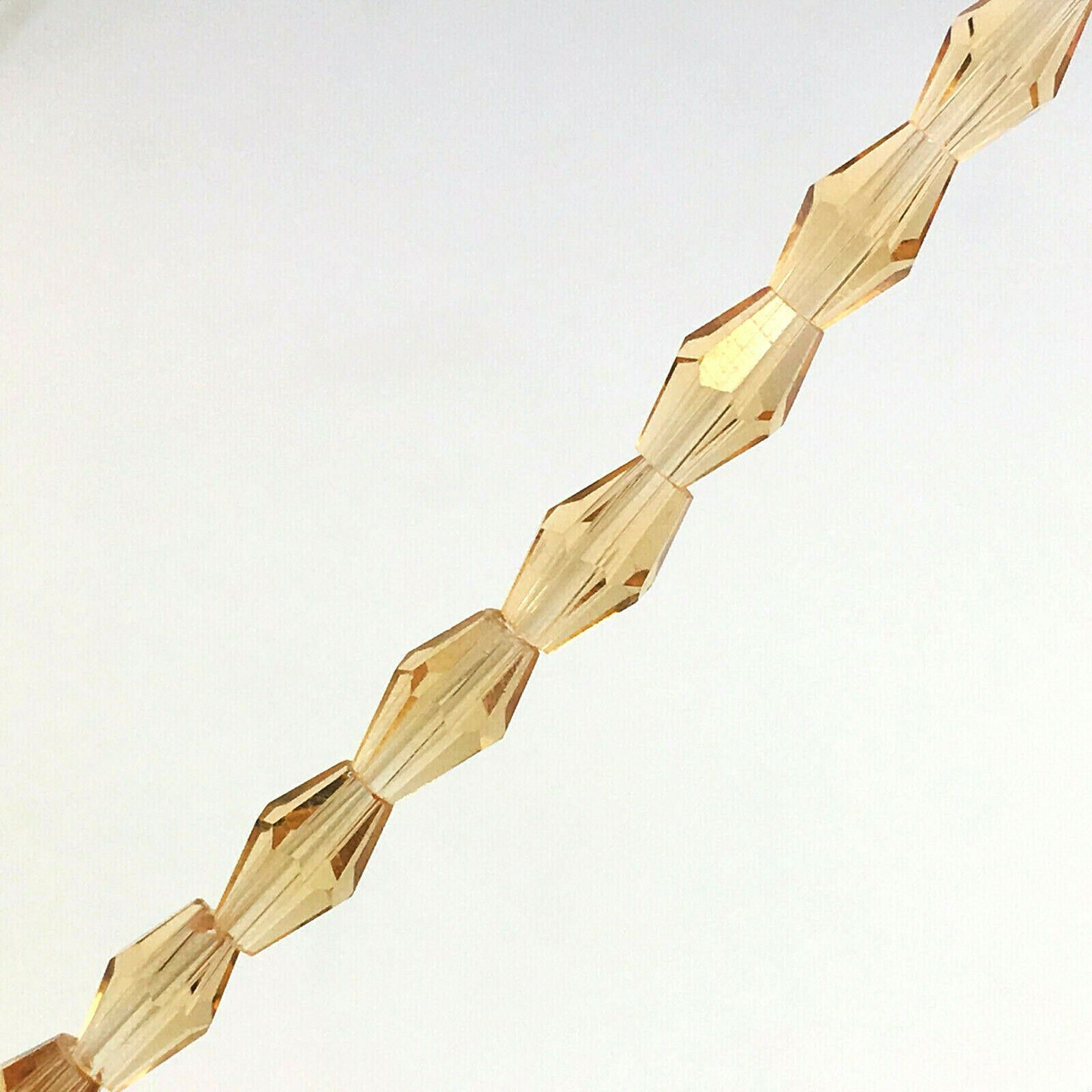 4x6mm Glass Crystal Elongated Bicone beads - PALE GOLD - approx 16-18" strand (70 beads)