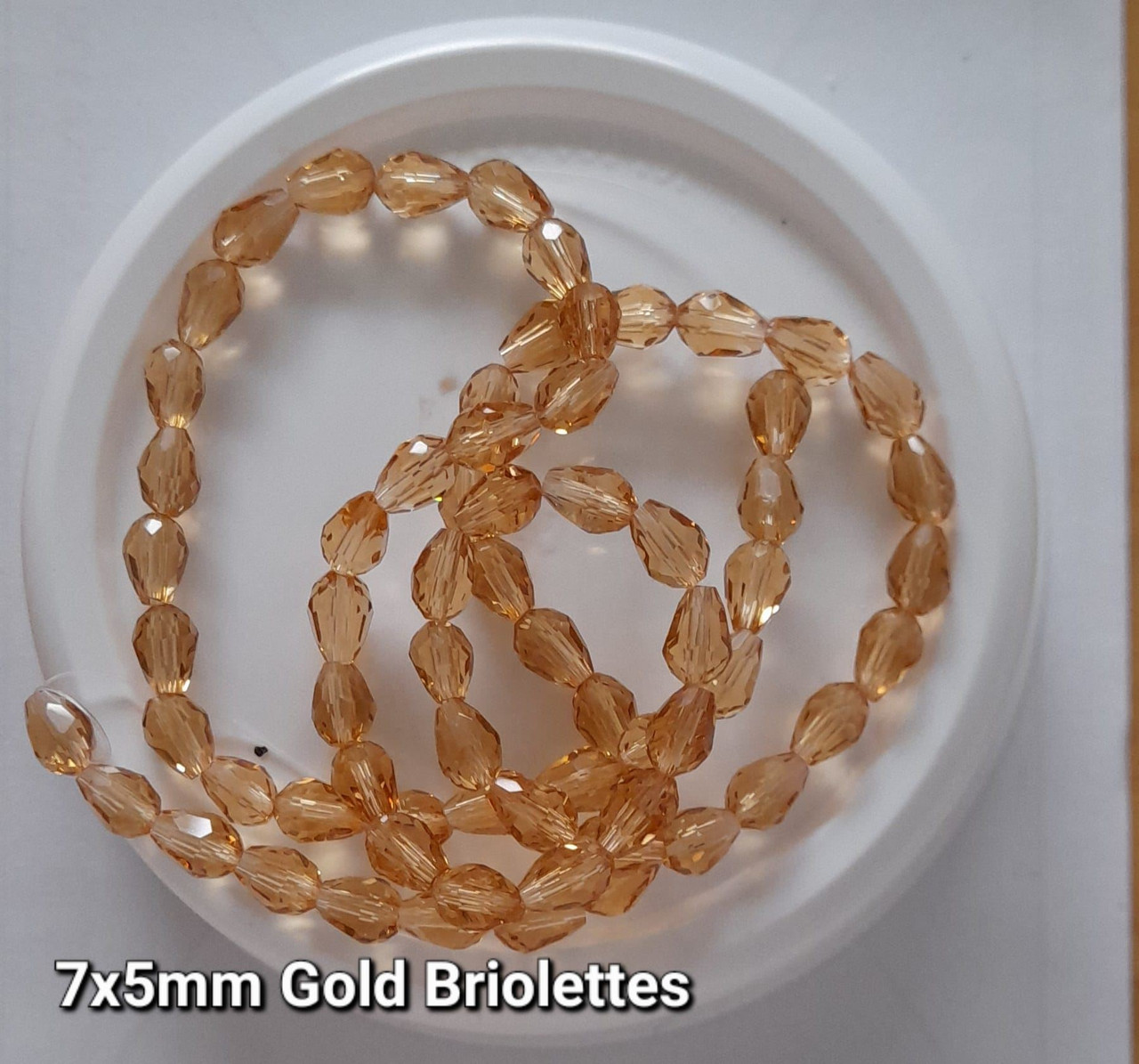 Strand of faceted drop glass beads (briolettes) - approx 7x5mm, Gold, approx 70 beads