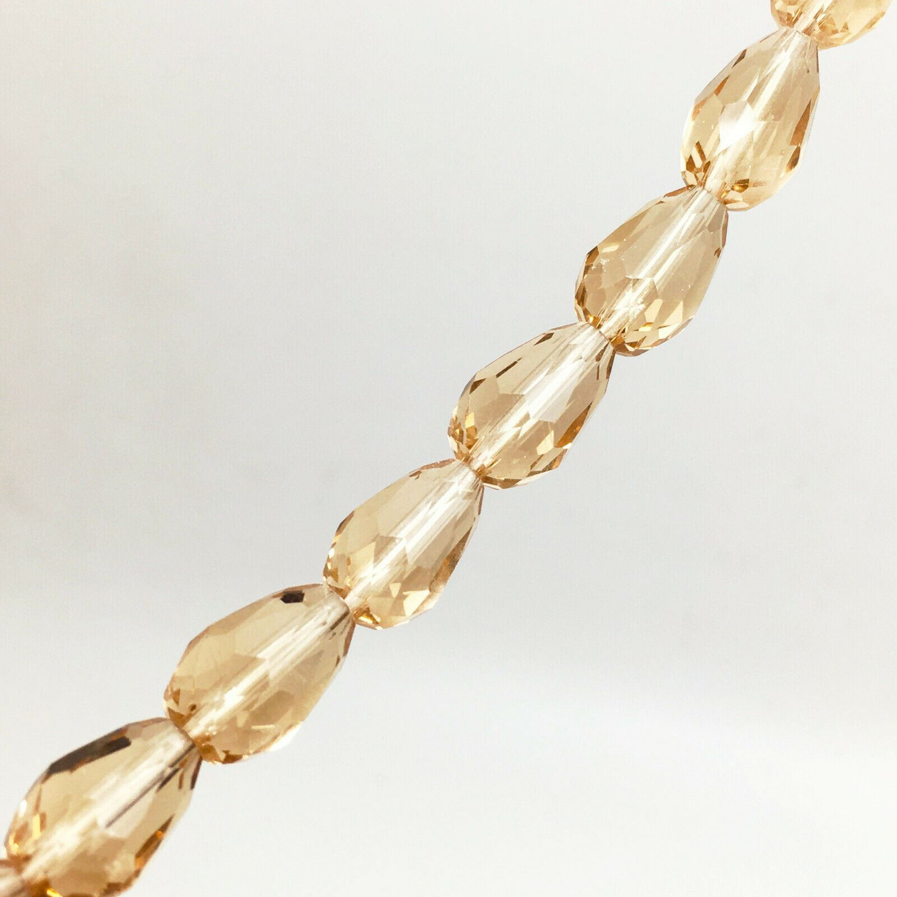 Strand of faceted glass drop beads (briolettes) - approx 11x8mm, Hint of Copper, approx 60 beads