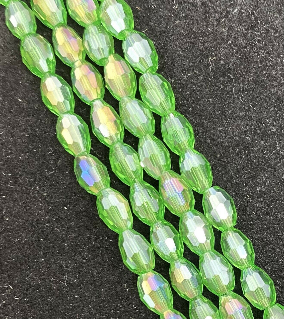 Strand of faceted rice glass beads - approx 6x4mm, Grass Green AB , approx 72 beads