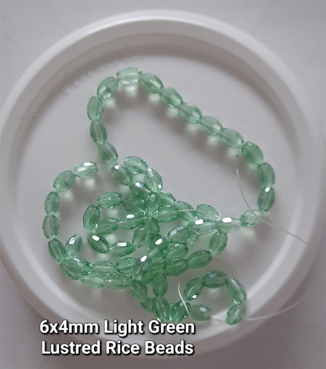 Strand of faceted rice glass beads - approx 6x4mm, Light Green Lustered, approx 72 beads