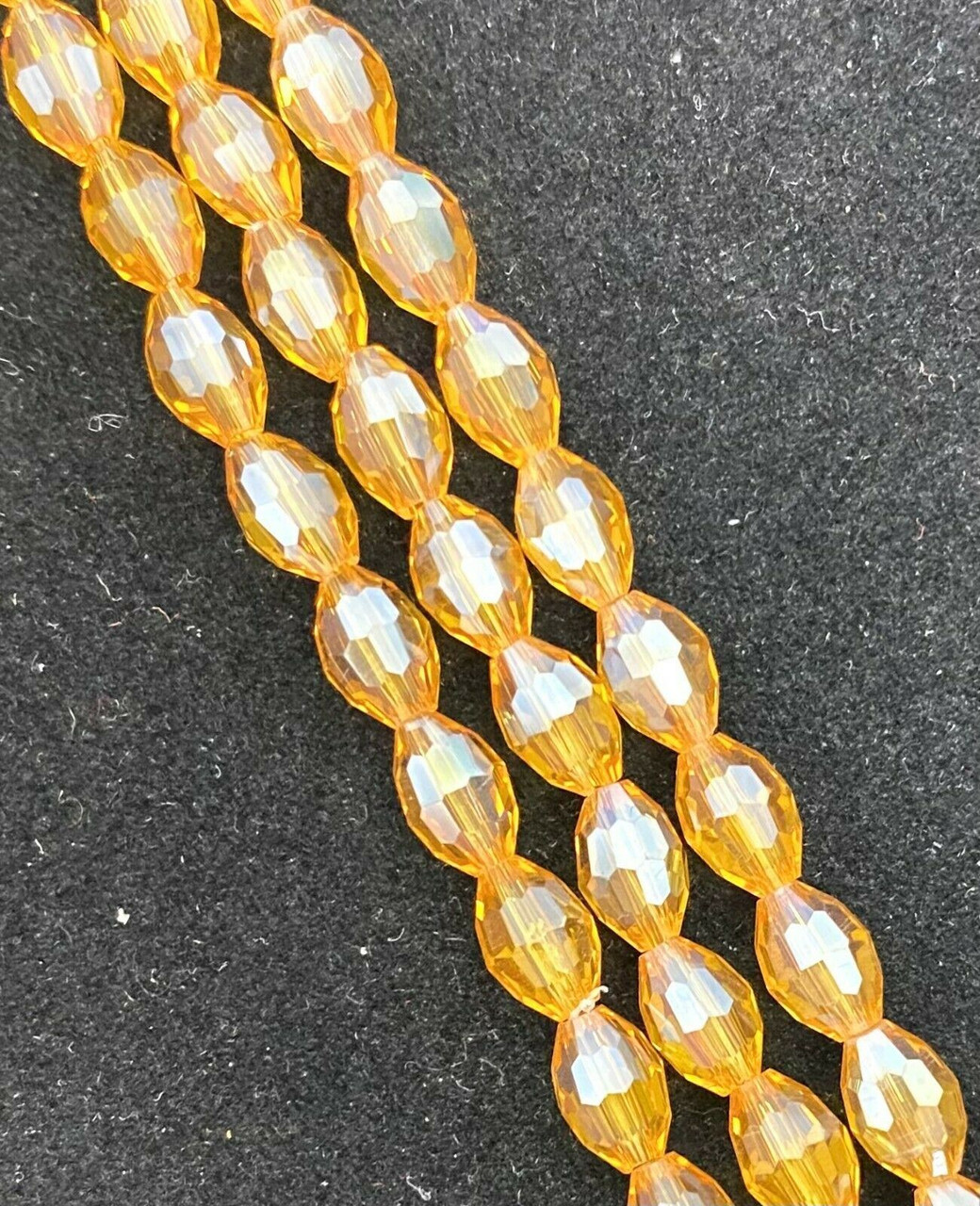 Strand of faceted rice glass beads - approx 6x4mm, Amber AB , approx 72 beads