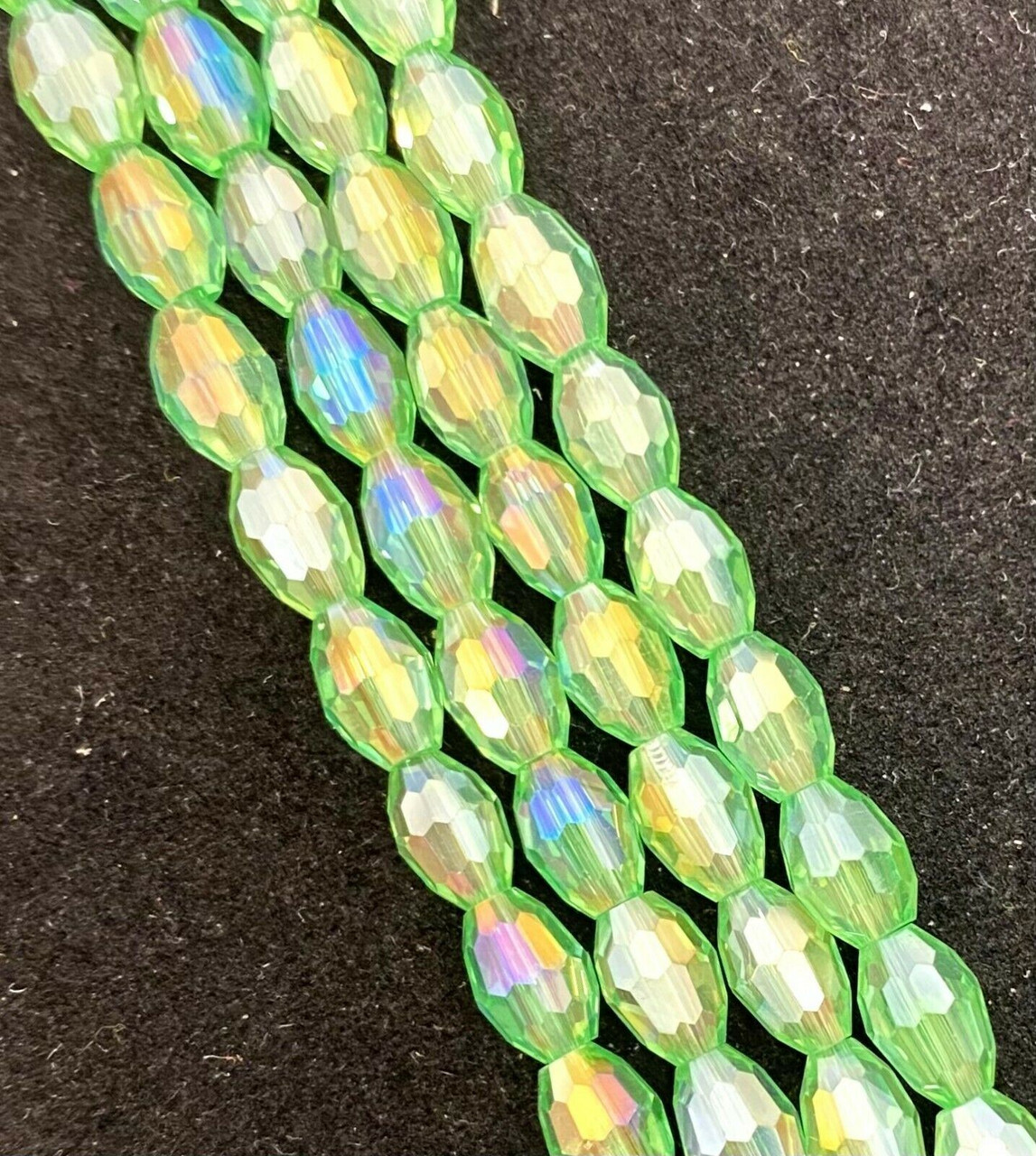 Strand of faceted rice glass beads - approx 6x4mm, Pale Green AB , approx 72 beads