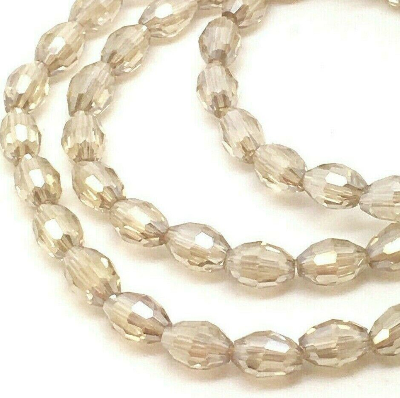 Strand of faceted rice glass beads - approx 6x4mm, Champagne Lustered, approx 72 beads