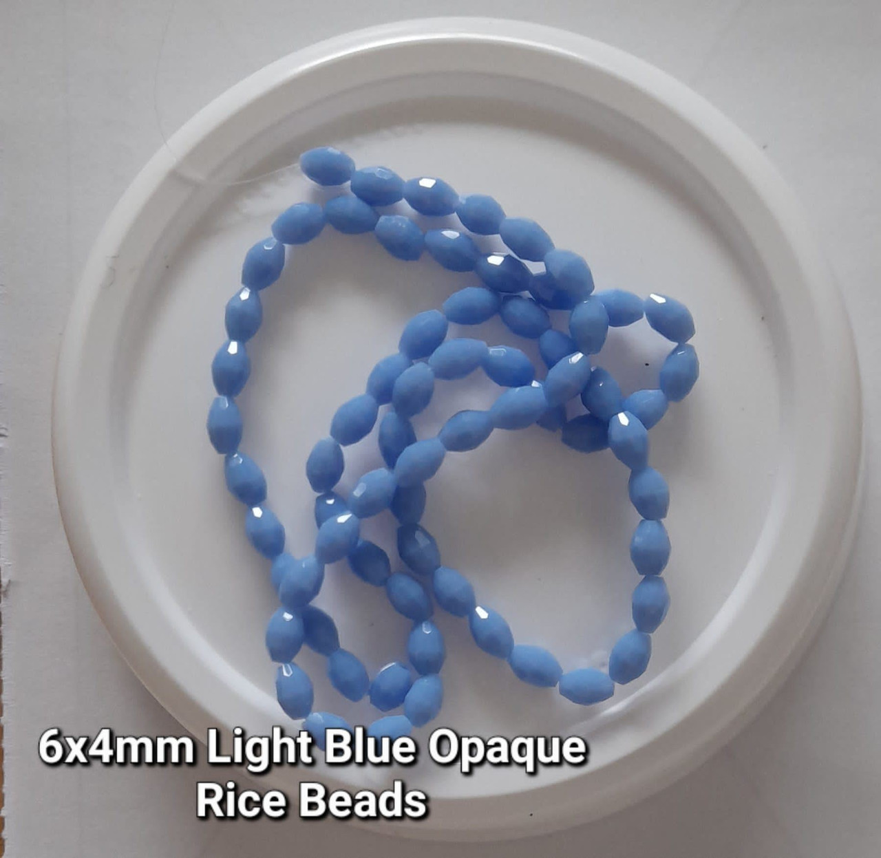 Strand of faceted rice glass beads - approx 6x4mm, Pale Blue Opaque, approx 72 beads
