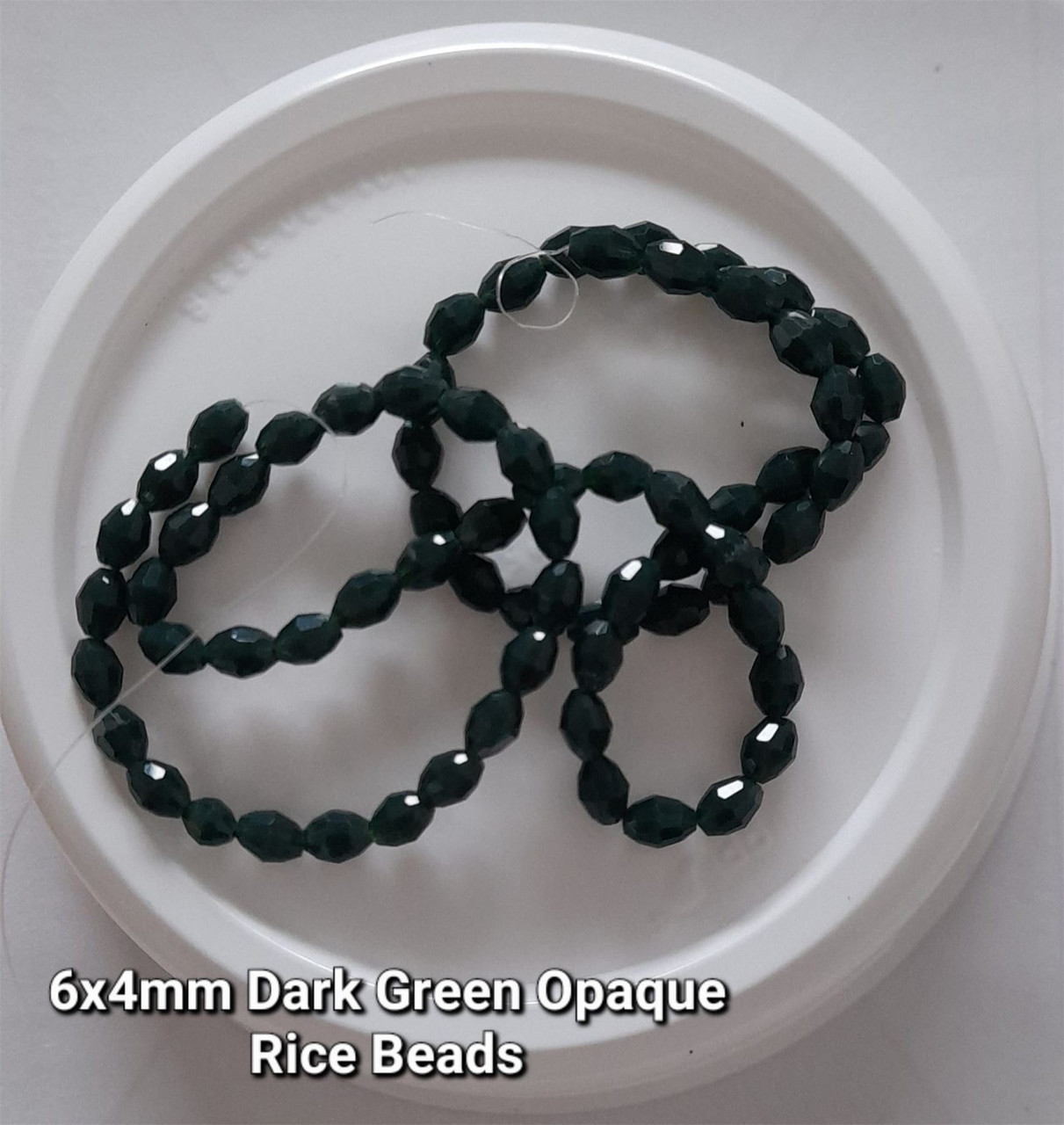 Strand of faceted rice glass beads - approx 6x4mm, Dark Green Opaque, approx 72 beads