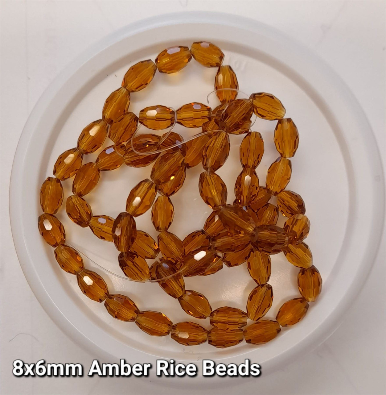 Strand of faceted rice glass beads - approx 8x6mm, Amber, approx 72 beads