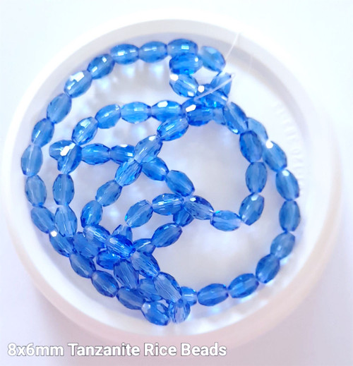 Strand of faceted rice glass beads - approx 8x6mm, Tanzanite (Light Blue), approx 72 beads